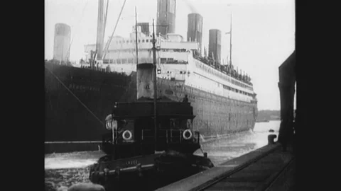 1912 - Massive crowds wave from the dock as the Titanic embarks on its voyage Stock Footage 126056950