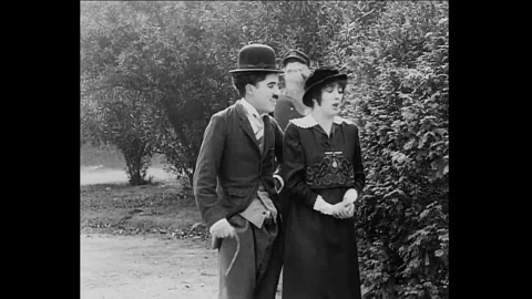 1914 - In this American comedy directed by Charles Chaplin, a police officer Stock Footage 241669464