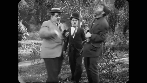 1915 - In this silent comedy, three men (including Charlie Chaplin) get into a Stock Footage 234501187