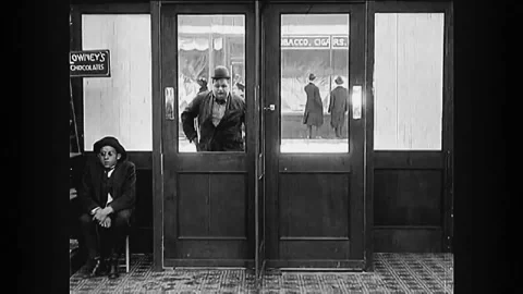 1916 - in this silent comedy, a chubby man has trouble getting through a Vídeos de archivo 246362515