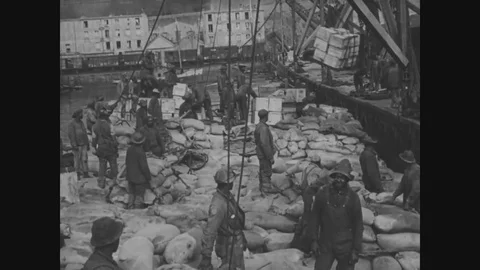 1918 - Men unload cargo at a dock in Brest, France. Stock Footage
