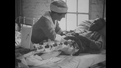 1918 - Nurses massage the joints of wounded soldiers in an AEF hospital. Stock Footage 100859787