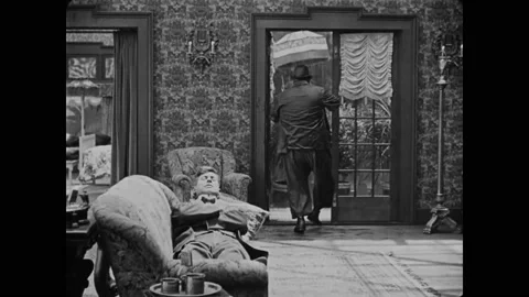 1918 - in this silent comedy, a man comes home with an organ grinder and a Stock Footage 246295644