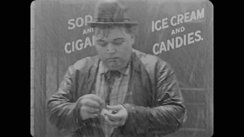 1918 - in this silent comedy, a man desperately tries to light his cigarette in Stock Footage 246296151