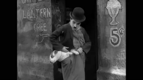 1918 - In this silent comedy, a man hides a dog in his wide pants before he Stock Footage 229352807