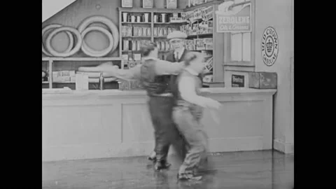 1920 - In this silent comedy, an auto garage employee (Buster Keaton) and his Stock Footage 241671630