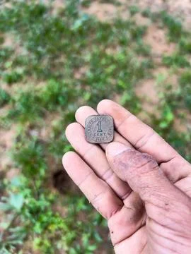 1920 Straits Settlements 1 Cent Coin in Hand Stock Photos