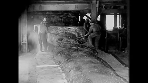 1920 - Workers at an electric furnace break up a crystal mass of carborundum and Stock Footage