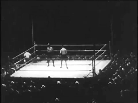 1920s -- Boxer, Gene Tunney, flexes his muscles, boxes, and jogs with trainers. Stock Footage
