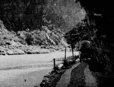 1920s - Covered wagon driving down dirt road, passengers exit carriage Stock Footage 170738061