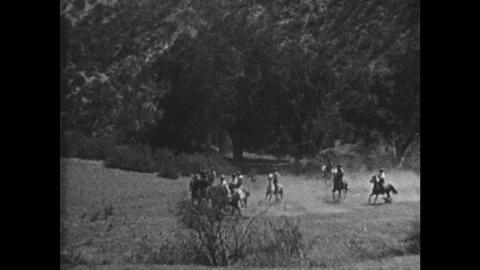 1920s: Cowboys chase Indians across plains on horseback. Cowboys and Indians Stock Footage