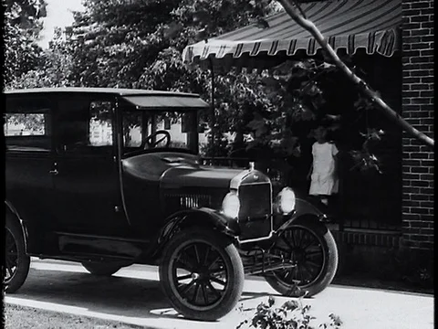 1920's Family Getting In Ford Model T and Driving Away Stock Footage 80357653