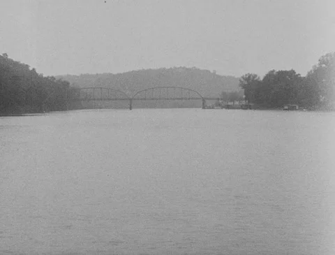 1920s - Floating Down River, Bridge in Distance Stock Footage 151446428
