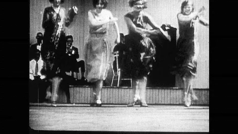 1920s: Four women dancing on stage. Woman dances with band on stage. Woman dance Stock Footage