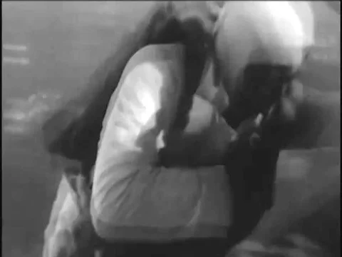 1920s,A man skydives, opens seven parachutes during his fall, and receives a Stock Footage 83215092