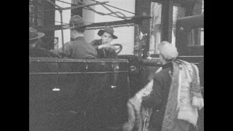 1920s: Men try to sell blankets to people waiting in vehicles. People sitting at Stock-Footage 86660087