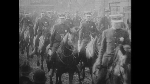 1920s: Parade.  Crowd.  Man waves hat from back of car.  Elephant wears sign.  Stock Footage 126014408