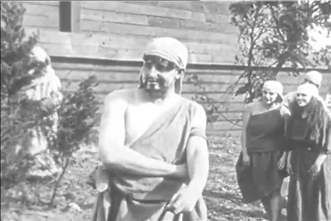 1920s reenactment of Noah's ark, Noah laughs as elephants are loaded onto the Stock Footage 99793333