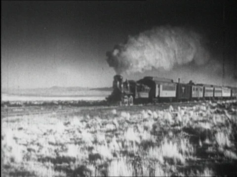 1920s: STEAM RAILROAD ENGINES: tracks, pistons, passengers at station Stock Footage