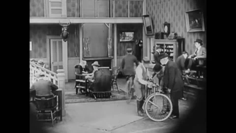 1921 - In this silent comedy, a telegram delivery boy rides his bike through a Stock Footage 241807284