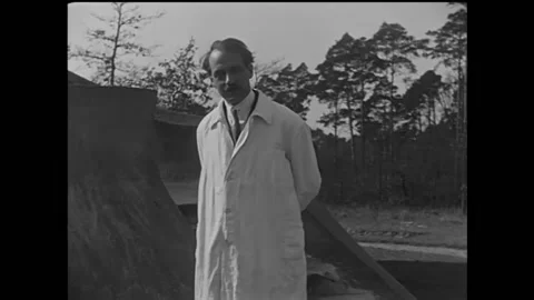 1922 - Albert Einstein uses a tower to illustrate his theory of relativity. Stock Footage 168931557