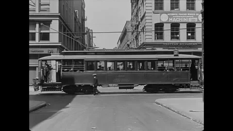 1922 - In this silent comedy, a horde of cops rushes off a streetcar to chase a Stock Footage