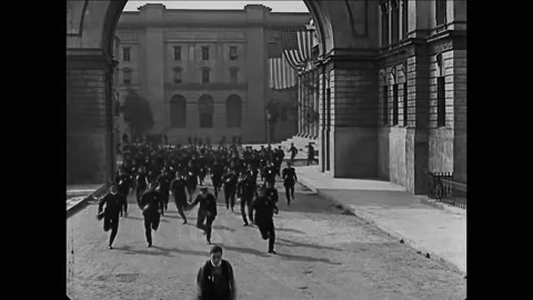 1922 - In this silent comedy, a man (Buster Keaton) running from a horde of cops Stock Footage 214335152