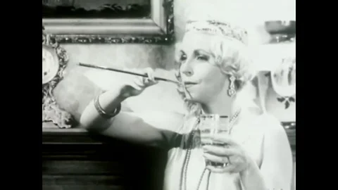 1923 - Female flappers use the Model 541 upright vacuum cleaner and listen with Stock Footage
