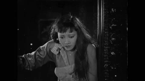 1923 - In this silent drama, two men are fighting. A wounded woman enters the Stock Footage 229352855