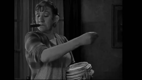 1924 - In this comedy, a couple is sitting at a table in the dining room when Stock Footage 234546677