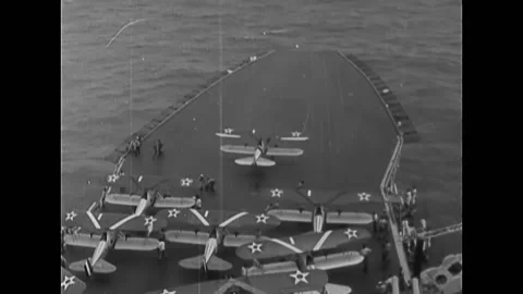 1925 - Fighting planes and dive bombers take off from aircraft carrier and fly Stock Footage 246280328