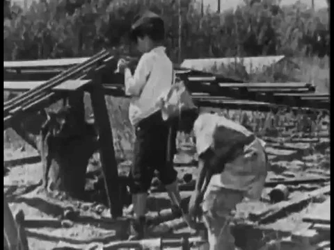 1925, Kids of rival gangs throw tomatoes at each other, a kid pours water on Stock Footage 83215472