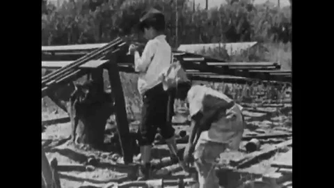 1925 Kids of rival gangs throw tomatoes at each other, a kid pours water on Stock Footage 115669157