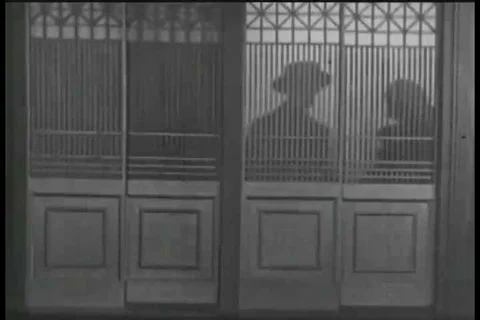 1925 - A man must stoop to scheming to get his mistress past a hotel detective. Stock Footage 99669730