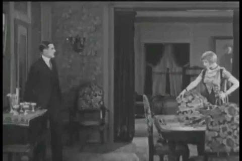 1925 - Tired of his wife accusing him of being unfaithful, a man tries to get Stock Footage 99669688