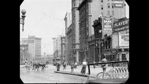 1925 - Vehicular traffic is seen in Winnipeg, Manitoba, Canada, and a train is 스톡 동영상 145394745