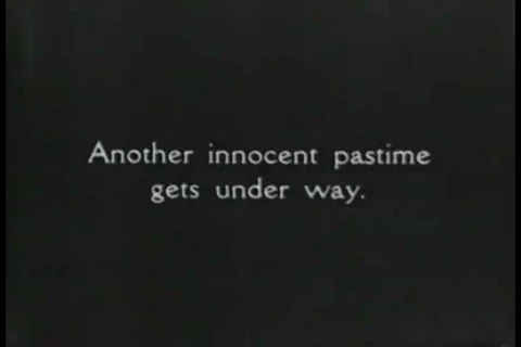 1926 - Caddies pass the time by shooting dice while waiting for golfers to come Stock Footage 99668731