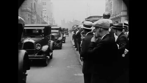 1926 - Pedestrians wait to cross an intersection filled with cars and trolleys Stock Footage 145395468