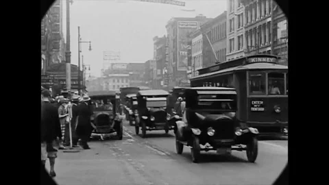 1926 - Pedestrians wait to cross an intersection filled with cars, trucks, Stock Footage 145395554