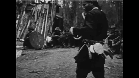 1927 - A shaman performs rites in a dance for huntsmen in a village of forest Stock Footage 115665182