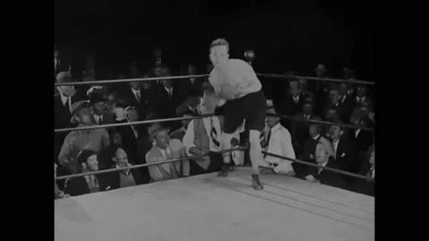 1927 - In this silent comedy, an eager boxer (Stan Laurel) jumps around the ring Stock Footage 238543726