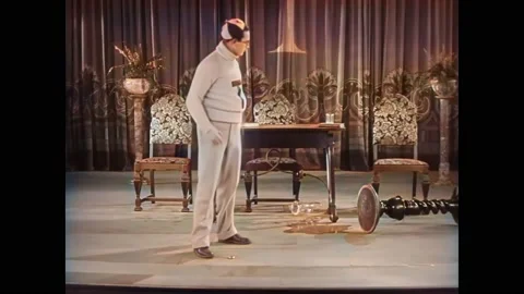 1927 - In this silent comedy, a man on a stage is talking to an audience, but he Stock Footage 232849615