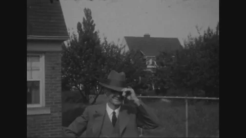 1929 - Albert Breen films his wife and daughter as they explore a flower field Stock Footage 79445989