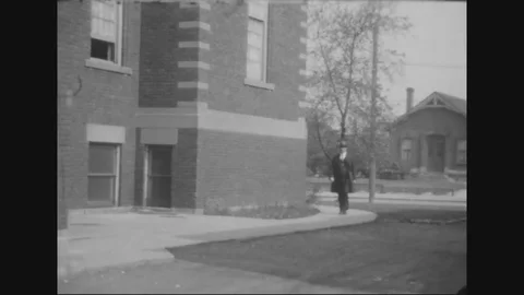 1929 - People leave a building, Albert Breens daughter plays on a swing, and Stock Footage 79446001