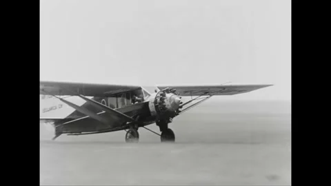 1930 - An air mail pilot takes off and grabs his baggage. Stock Footage 155795662