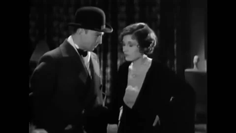 1930 - In this American pre-code crime action film, a man grabs a woman by the Stock Footage 238772655