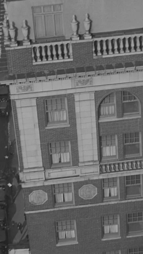 1930 - A daredevil performs balancing acts on stacked furniture atop a roof in Stock Footage 284125249