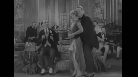 1930 - In this short comedy, a couple sing and dance with each other for another Stock Footage 232882344