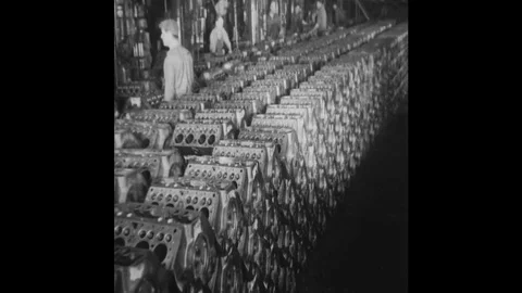 1930s-1940s : A stack of v8 engine blocks sits on a Henry factory floor.  Stock Footage 74532695