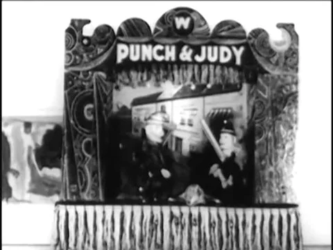 1930s _ Children watch a Punch and Judy puppet show. Stock Footage